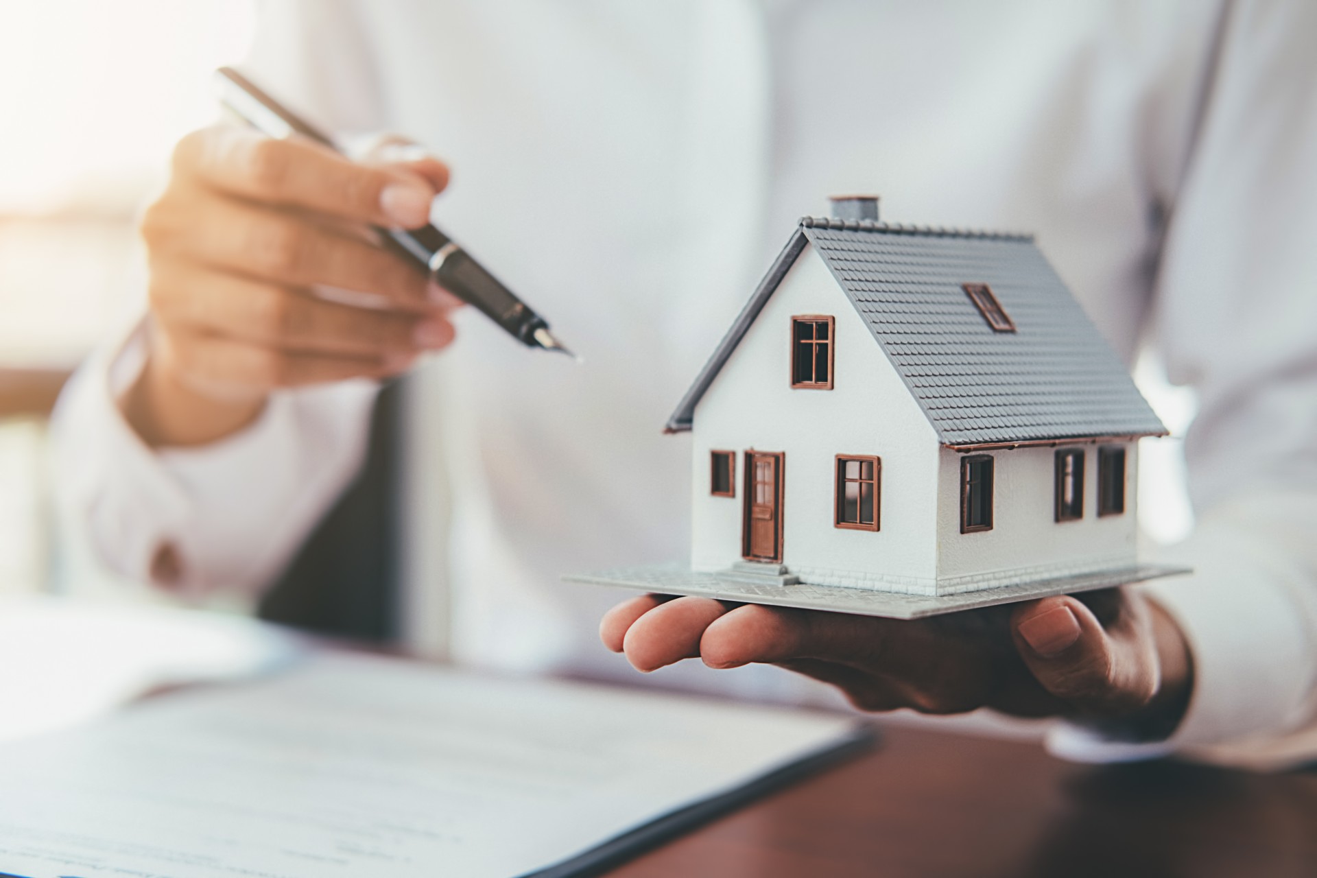 house model with real estate agent customer discussing contract buy house1